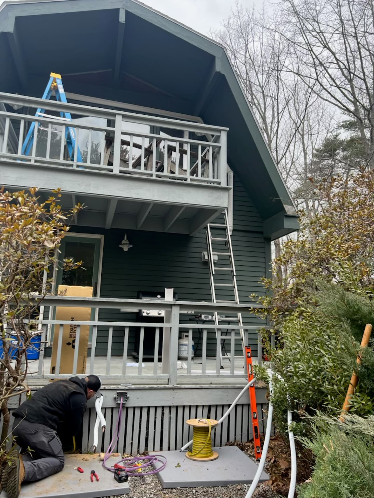 Technician installing an outdoor heat pump condenser unit
