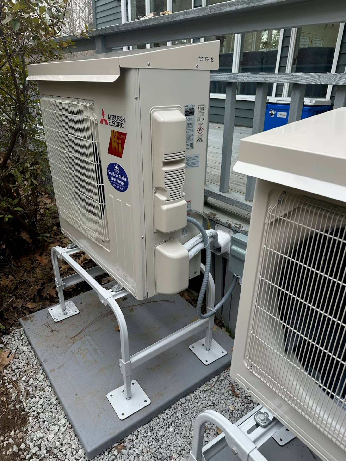 Close-up of outdoor condenser units on a gravel pad