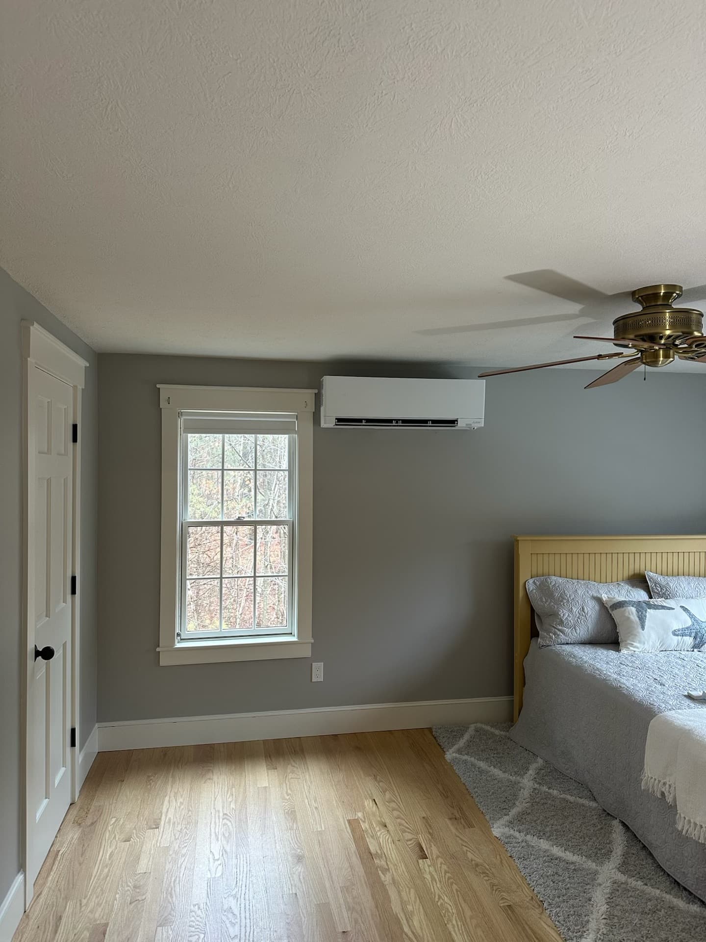 Mini-split head unit installed in a bedroom with gray walls