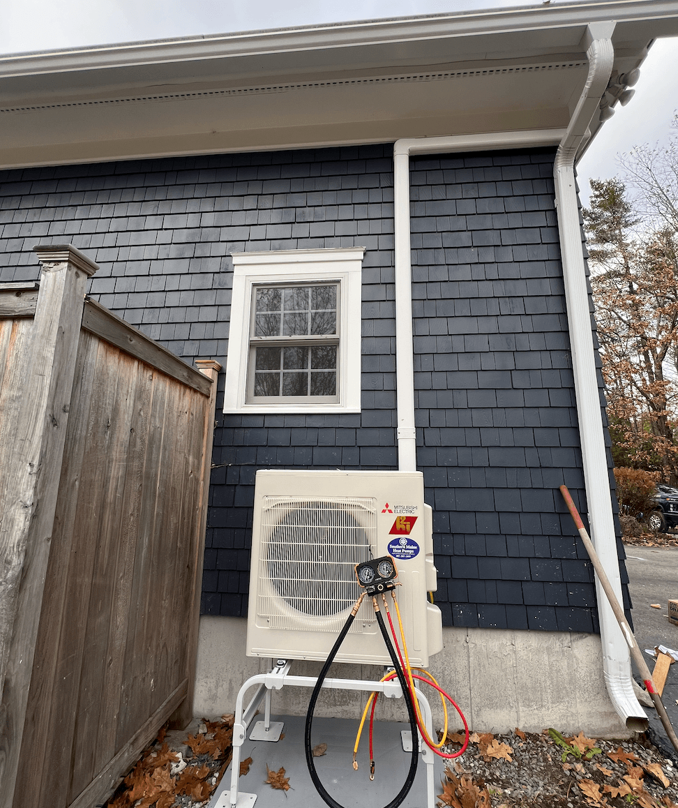 Southern Maine Heat Pumps technician inspecting a heat pump system